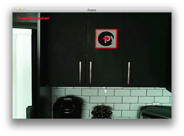 Figure 2: Detecting a PyImageSearch logo "target" from my quadcopter video stream using Python and OpenCV.