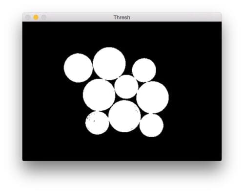 Figure 3: Applying Otsu's automatic thresholding to segment the foreground coins from the background.
